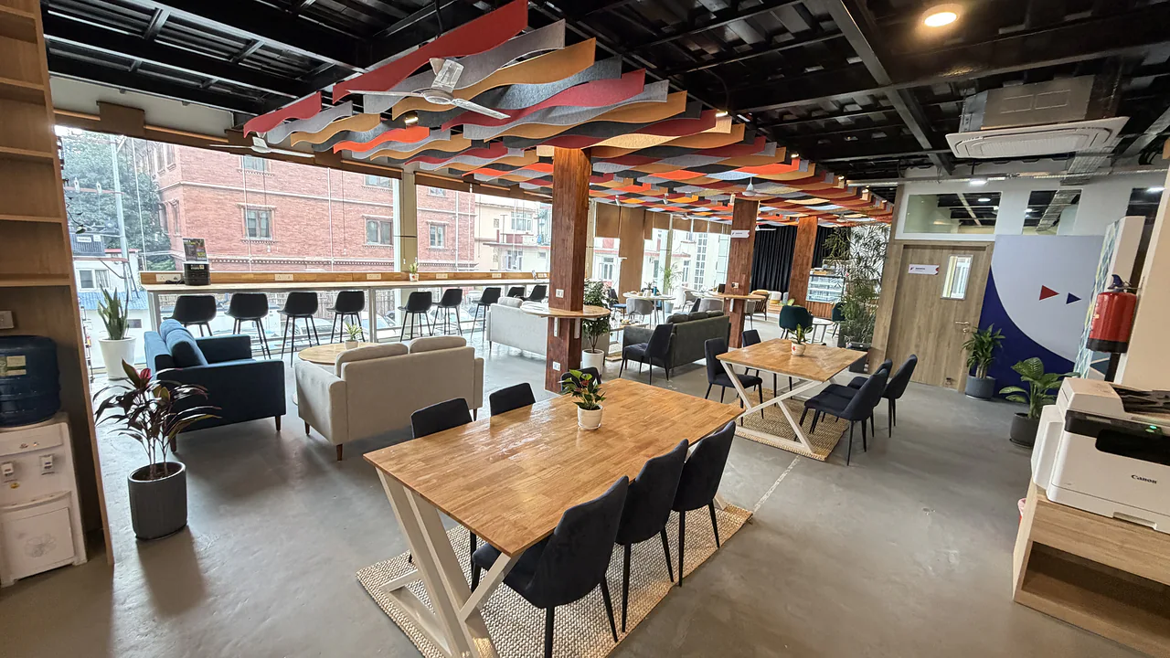 The CHQ co-working and café floor, with long tables under a colourful ceiling