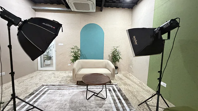 Camera and lighting gear on a teal set