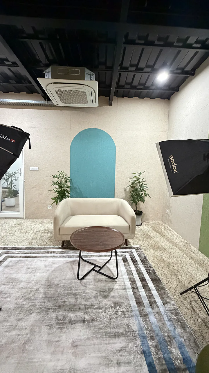 The CHQ teal studio set with two softboxes and a sofa