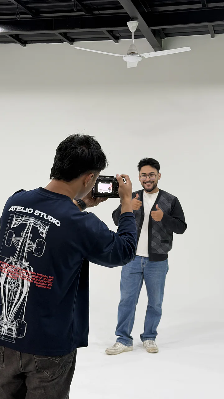 A creator filming a shoot on the white cyclorama at CHQ