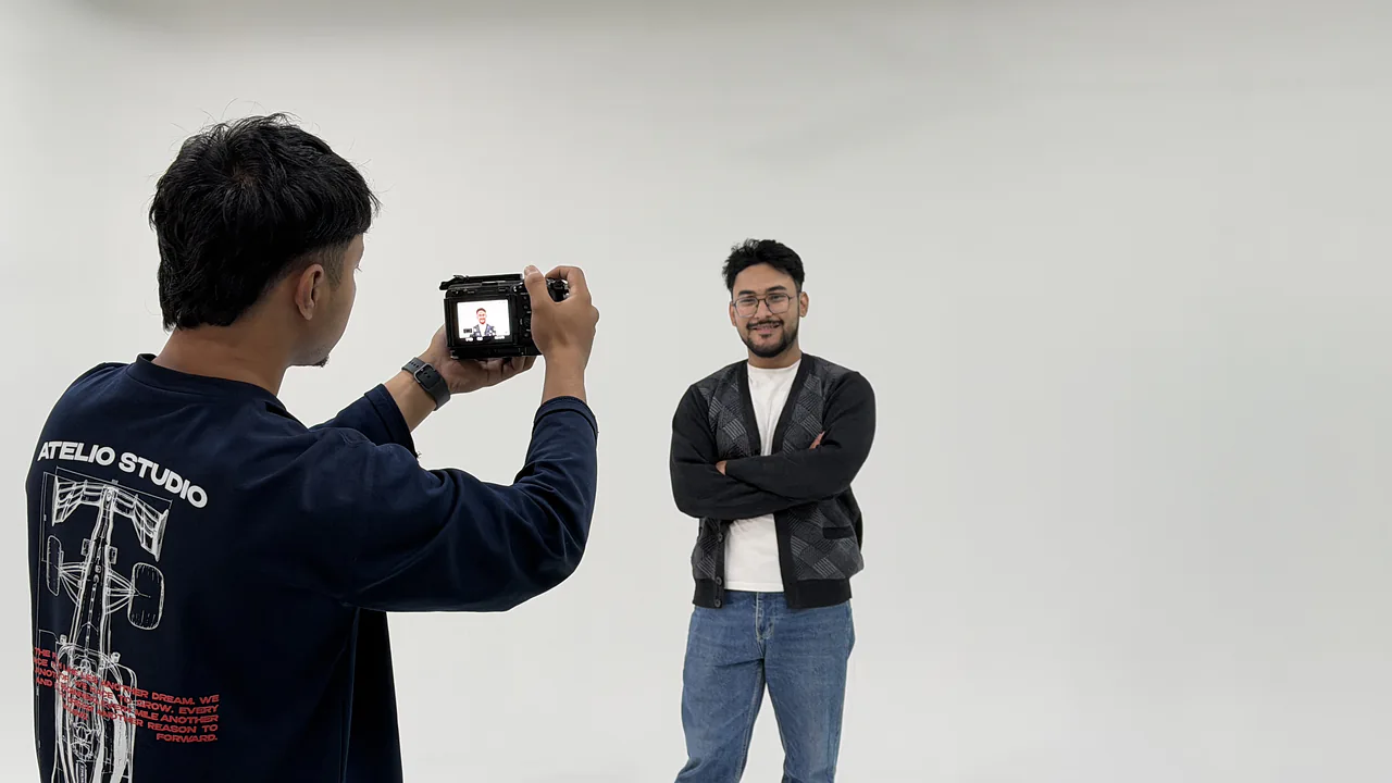 A photographer shooting a portrait of a creator in the CHQ studio